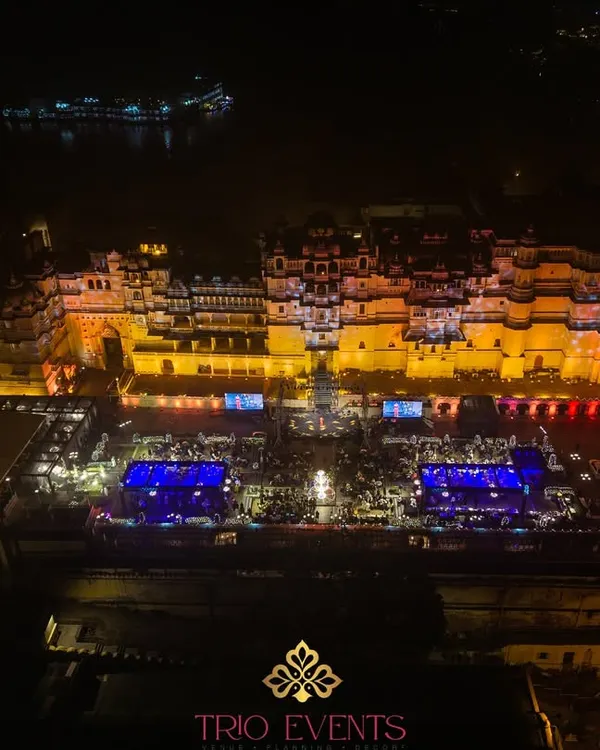 An aerial drone view of a grand Sangeet setup at Manek Chowk, City Palace Udaipur. I manage the complex logistics of large-scale events in heritage locations, transforming the entire space into a breathtaking spectacle.