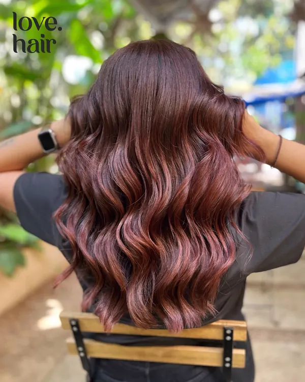 Blue skies and cherry cola floats. This look is right on trend, with deep red and violet tones creating the perfect cherry cola colour, styled in beautiful, soft waves.