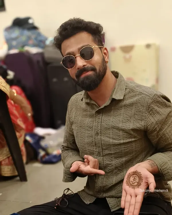 Mehendi isn't just for brides. I create stylish and simple designs for grooms too, like this personalized initial in a mandala, so they can be a part of the tradition in their own way.