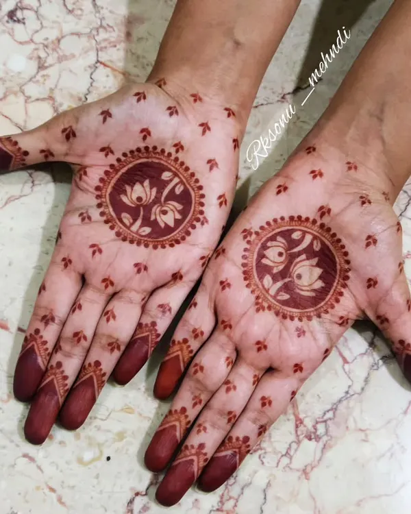 This is the beautiful, deep red stain that my herbal henna produces. The design, featuring a lotus and swans, looks even more stunning with this rich color. No filters needed, just the magic of pure henna.