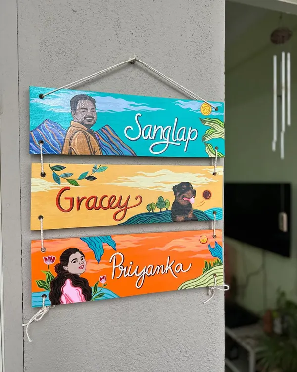 This three-tier nameplate was a beautiful surprise gift we created. It features portraits of Priyanka, her husband Sanglap, and their fur baby Gracey, each on their own colorful, themed plank.