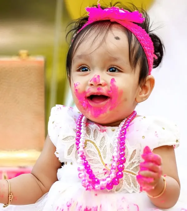 The pure joy of a first birthday cake smash! This close-up captures the delightful mess and happy expression that makes these sessions so memorable.