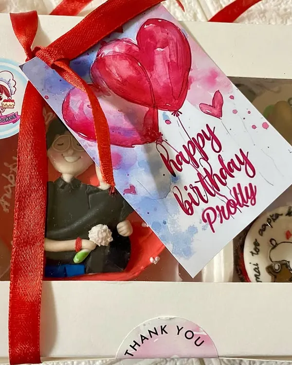 The complete gift experience. We package our custom bakes in a beautiful window box, tied with a ribbon and a personalized 'Happy Birthday' tag for that extra special touch.