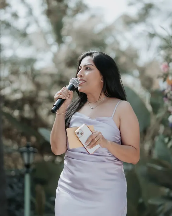 A candid shot of me speaking at an outdoor wedding. Even when not posing for the camera, my focus is always on the audience and the flow of the event.