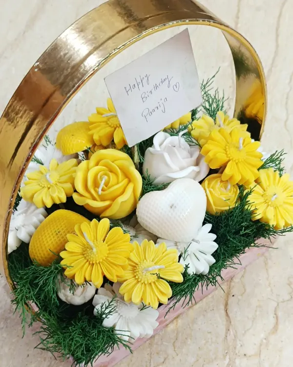 This candle bouquet basket is a unique and fragrant alternative to traditional flower arrangements. Filled with an assortment of yellow and white flower-shaped candles, it makes for a stunning and lasting gift for birthdays or thank yous.