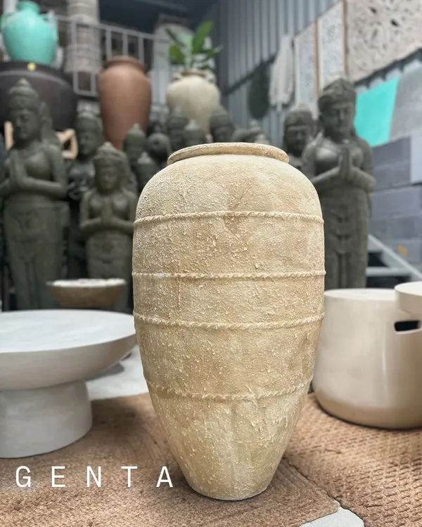 The 'Genta' planter is a beautiful example of neutral, textured decor. Its sandy finish and rope-like bands give it a rustic yet sophisticated feel, perfect for a minimalist or coastal aesthetic.