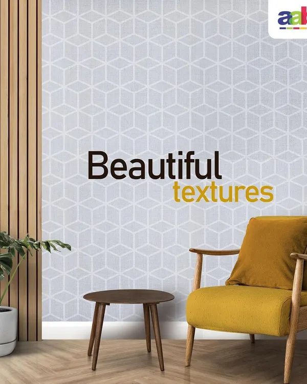 A modern living space featuring a stunning accent wall with a light grey geometric cube pattern. This textured wall finish adds depth and a contemporary feel, perfectly complemented by the minimalist wooden furniture and a pop of colour from the yellow armchair.