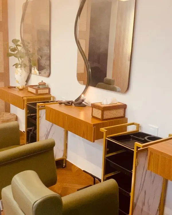 Our styling stations are designed with both comfort and elegance in mind. The blend of natural wood, soft lighting, and ergonomic chairs creates a perfect space for your hair care rituals.