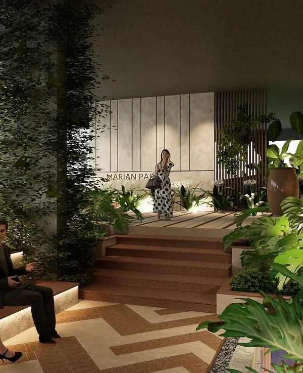 The clubhouse entrance for Marian Park in Mangaluru is designed as a journey through nature. Tiered seating, rich wooden steps, and abundant tropical plants guide visitors, creating a sophisticated and serene arrival experience.
