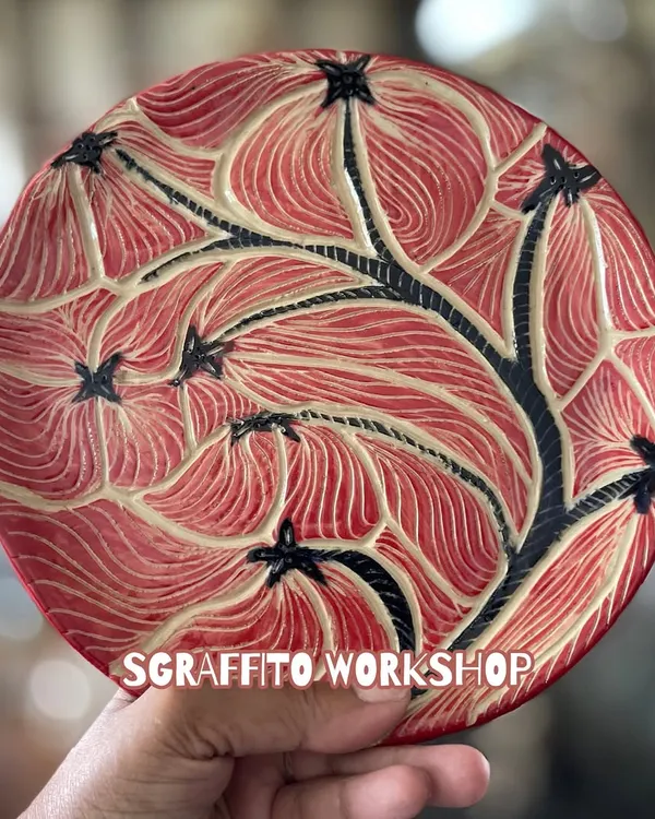 This is a perfect example of a finished Sgraffito plate. The intricate floral pattern was carefully carved by a student, and after firing and glazing, the design really comes to life with a rich, vibrant finish.