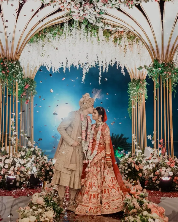 A perfect moment under a sky of confetti and a canopy of flowers. We focus on capturing these grand, fairytale moments that feel like they are straight out of a movie, ensuring your wedding photos are as magical as the day itself.