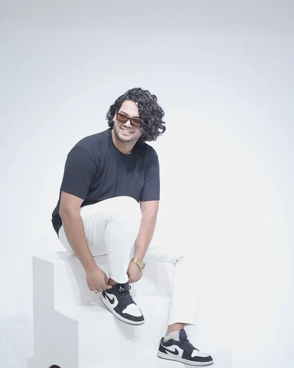 A shot from a studio photoshoot, tying up my Jordans. A clean, minimalist look.