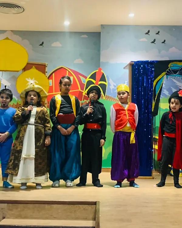 The full cast of our Aladdin musical takes a bow. My theatre workshops culminate in a final performance, giving children the thrilling experience of being on stage.