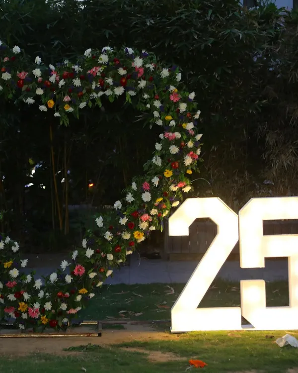 Celebrating a silver jubilee! I created this large, heart-shaped floral arch and provided light-up "25" marquee numbers for a beautiful 25th-anniversary party backdrop.