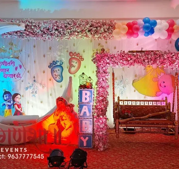 A complete stage setup for a grand Dohale Jevan, or baby shower ceremony. I designed this with a large, custom-made crescent moon prop, a beautifully decorated jhula for the mother-to-be, and themed elements like Krishna and Radha cutouts to create a magical atmosphere.
