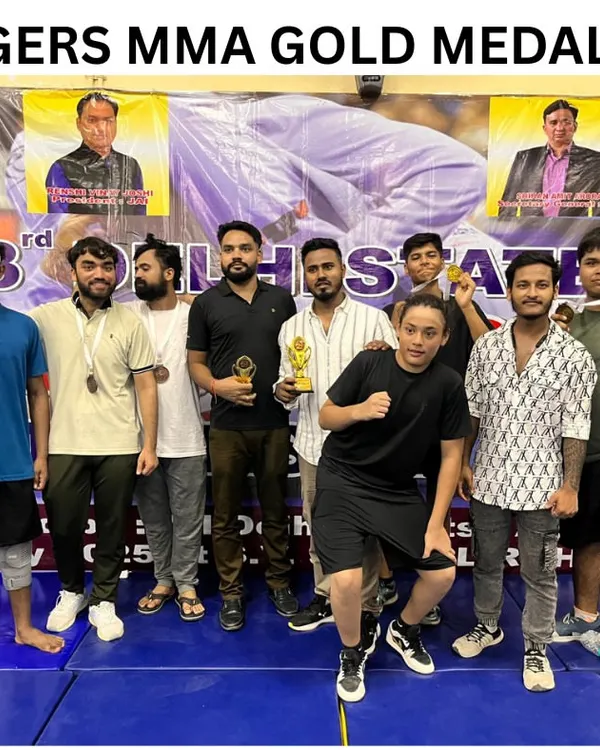 The team celebrating after a successful tournament. These medals and trophies are proof of our dedication. We are the Tigers MMA gold medalists.