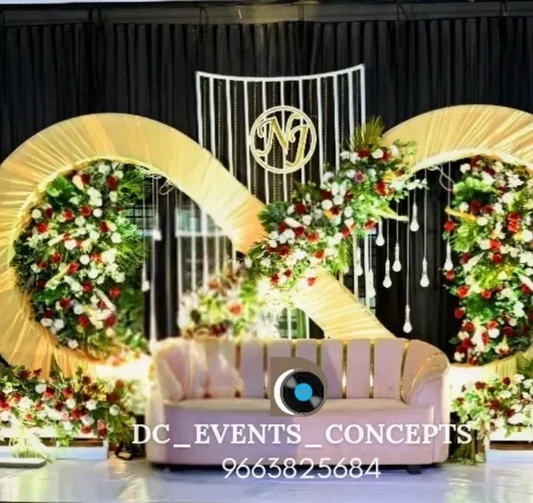 A unique and symbolic engagement stage featuring a golden infinity symbol adorned with flowers. This design represents eternal love and creates a stunning, modern backdrop for the couple.