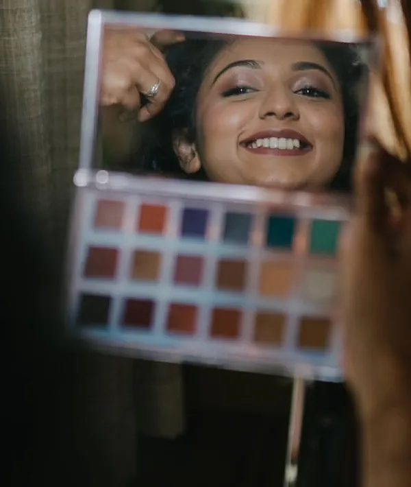 A candid moment of the bride seeing her makeup in the mirror. That happy smile is what it's all about.