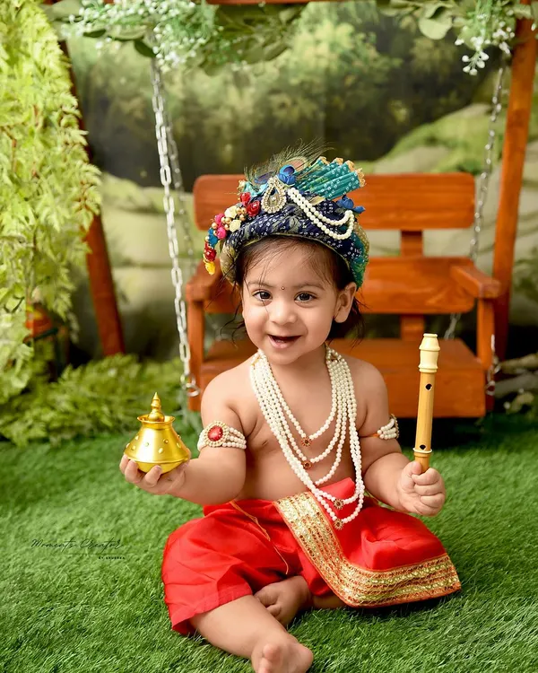 The most charming little Krishna with a mischievous smile. Holding a golden bell and his flute, this little one perfectly embodies the playful spirit of Kanha.