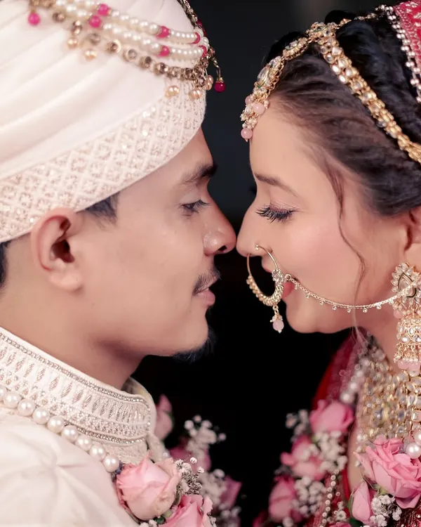 An intimate close-up of the bride and groom, nose to nose, capturing a moment of pure connection and love.