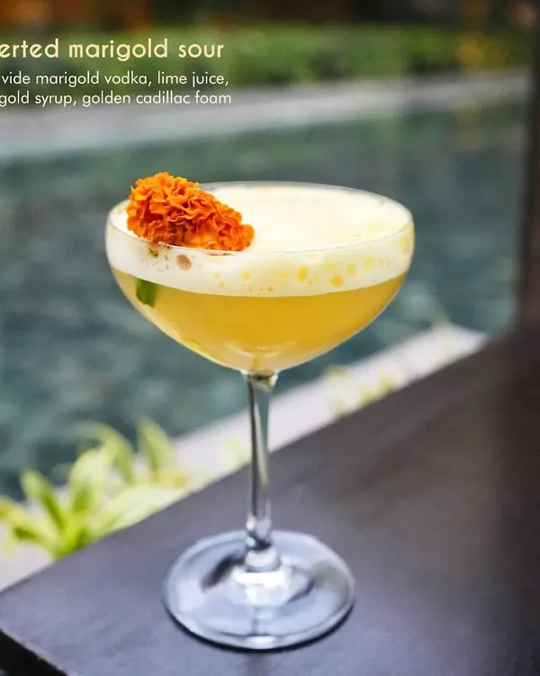 Our Inverted Marigold Sour is a celebration of floral flavors. We use sous vide marigold vodka, fresh lime juice, and a delicate marigold syrup, topped with golden cadillac foam. The result is a bright, aromatic, and visually stunning cocktail.