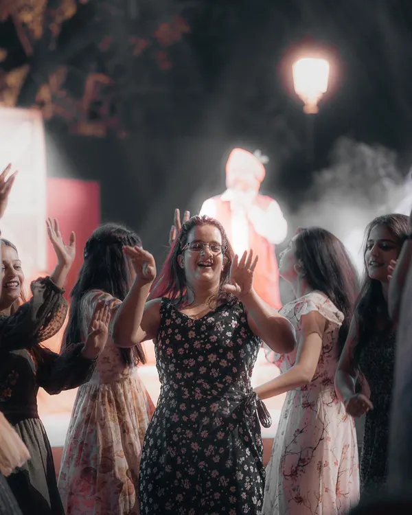 A young woman in the audience dances with a huge smile, completely lost in the moment. These are the candid shots that truly capture the spirit of a live event.