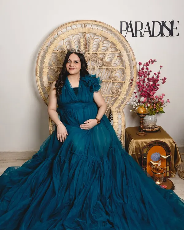 Seated like a queen on a throne, because that's what every mother is. This portrait is designed to be regal and powerful, celebrating the mom-to-be in all her glory.