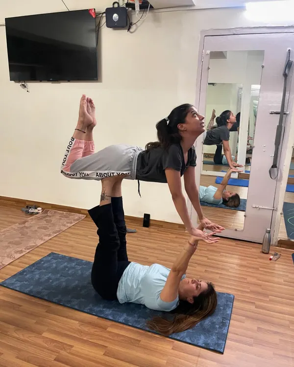 This classic acroyoga pose, known as "Front Bird," is excellent for beginners. The base builds leg strength and stability, while the flyer develops core control and balance.