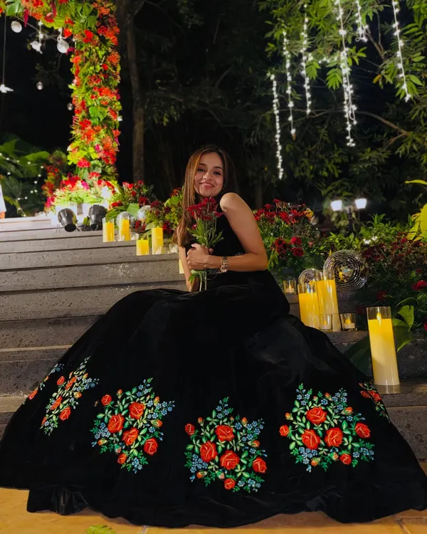 A quiet moment before the storm of the party. This beautiful black gown with floral embroidery was perfect for a romantic and elegant evening reception.