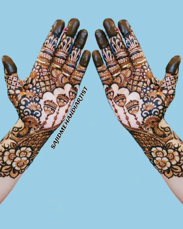 This symmetrical, full-hand design is a perfect example of heavy guest mehandi. The pattern is dense with fine lines and traditional motifs, ensuring a dark, rich stain.