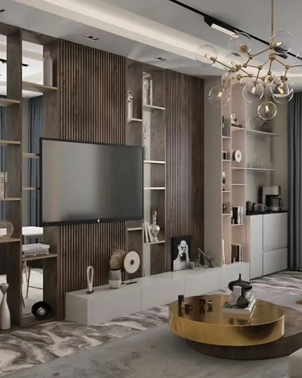 A sophisticated living room featuring a full-wall TV unit with dark wood paneling and a white console. The unit is paired with an open-shelf partition that stylishly separates the living and dining areas.