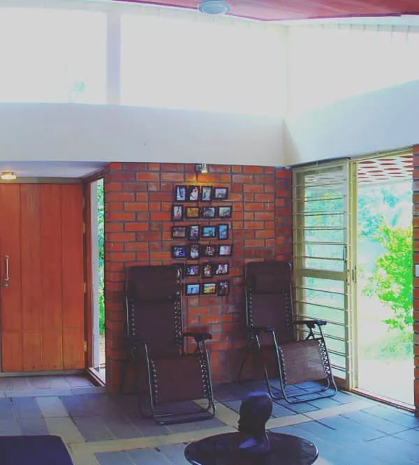 This living space captures my core belief in sustainable, vernacular design. The exposed brick walls provide texture and warmth, while the high clerestory windows flood the room with natural light, creating an airy and energetic home that connects with the outdoors.