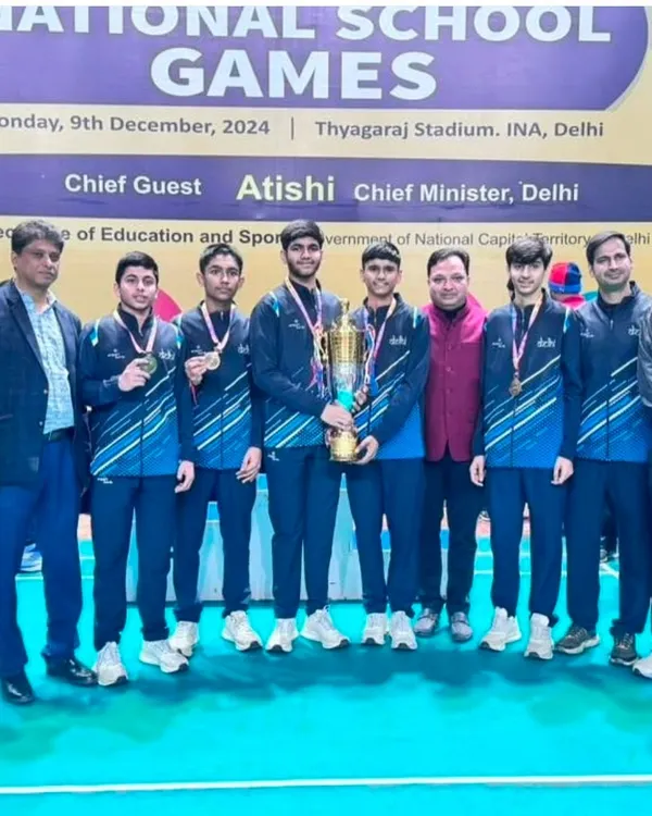 The team celebrating a major victory at the National School Games in Delhi. Holding the championship trophy is a testament to their collective effort and rigorous training.