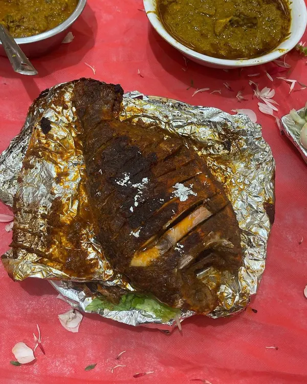 A whole grilled fish, served on foil to keep it hot and juicy. This is a popular choice for groom's tables and special family dinners.