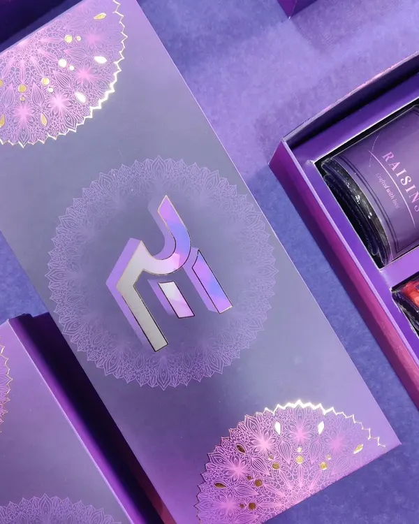 An example of our premium custom packaging capabilities. This purple gift box for a corporate client features their logo in a stunning holographic foil finish, complemented by intricate silver mandala patterns for a truly luxurious feel.