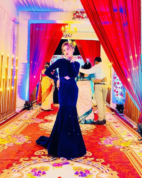 A client looking absolutely stunning in a royal blue velvet mermaid gown I designed for a wedding reception. The dramatic silhouette and rich fabric make it a real head-turner.