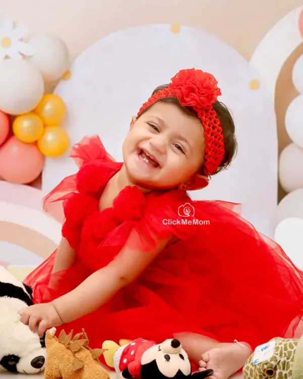 This is the kind of pure, unfiltered joy I aim to capture in every session. This little one's radiant smile in her vibrant red dress is a perfect memory of her milestone celebration.