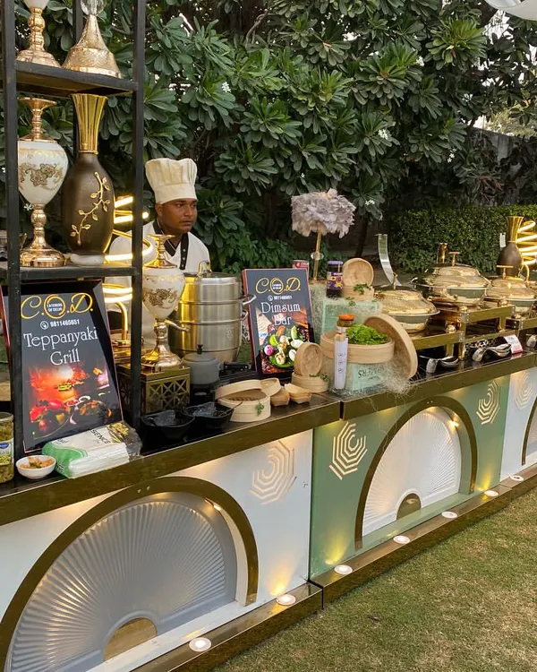 A full view of our Teppanyaki and Dimsum grill station at an outdoor event. The setup is designed for interaction, with uniformed chefs ready to cook fresh for your guests on this elegant, illuminated counter.