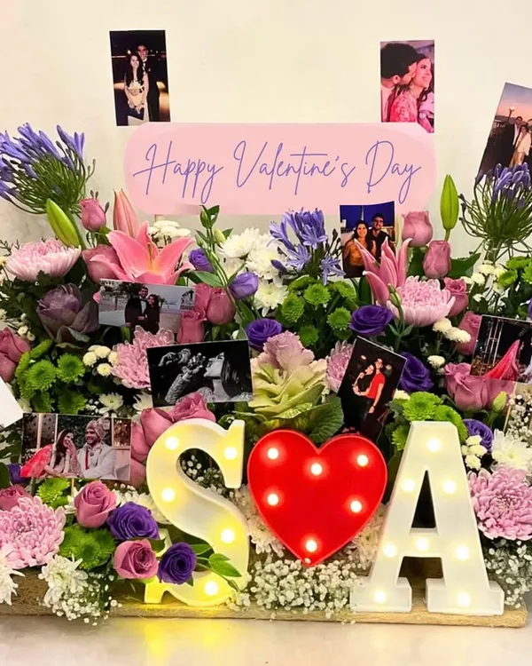 I believe in making grand romantic gestures unforgettable. This bespoke Valentine's Day arrangement was created with a garden of fresh flowers, personalized photos, and light-up initials to celebrate a unique love story.