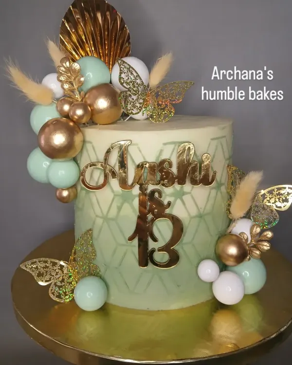 A stylish and modern cake for a 13th birthday. The mint green and gold color scheme is perfect for a teenager's celebration.