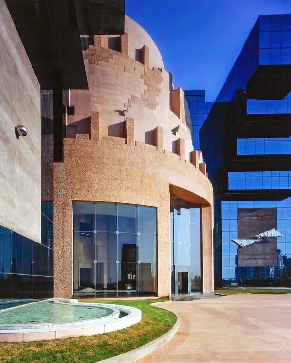The Unit Trust of India HQ, the first building in Mumbai's BKC district, was designed to project stability and a futuristic outlook. Its form is an amalgamation of historical influences and contemporary adaptations, creating a timeless architectural statement.