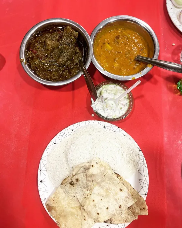 A classic combination of Bhaji Gosht (mutton with spinach) and dal, served with soft rumali roti. This is a hearty and traditional meal option.