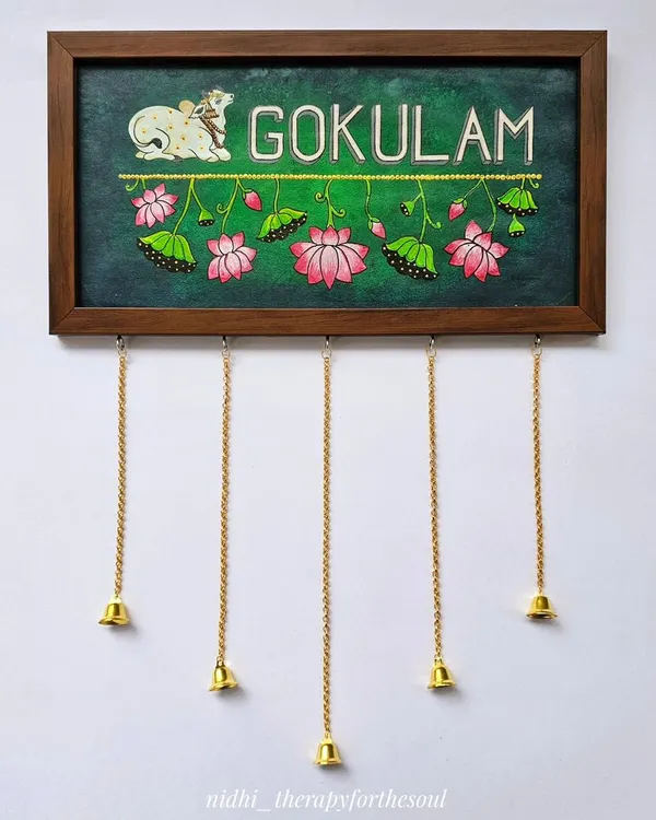 I love creating custom nameplates that reflect a family's personality. This "Gokulam" nameplate features a Pichwai-style cow and lotus details on a rich green background, complete with little hanging bells for a charming touch.