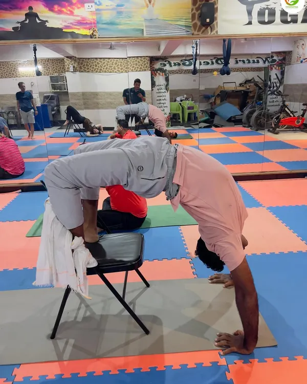 Using a chair for support allows for a much deeper and safer backbend in Chakrasana (Wheel Pose). This method helps open the chest and shoulders without putting pressure on the wrists or lower back.