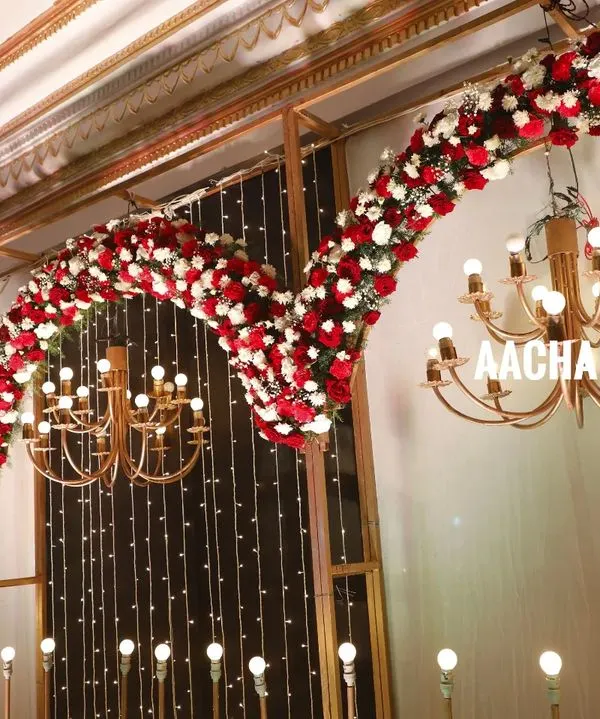 Here’s a closer look at the details that make a stage special. This shot highlights the dense, hand-arranged floral arches and elegant chandeliers from one of our premium indoor setups, showing the quality of our event production work.