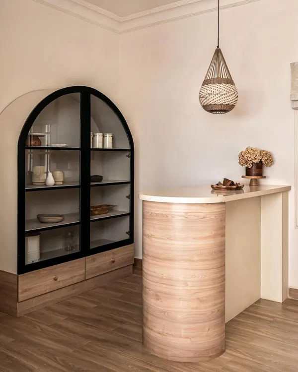 A statement bar I designed for a client who loves to host. The curved oak base, marble top, and arched display cabinet create a sophisticated and welcoming entertainment hub.