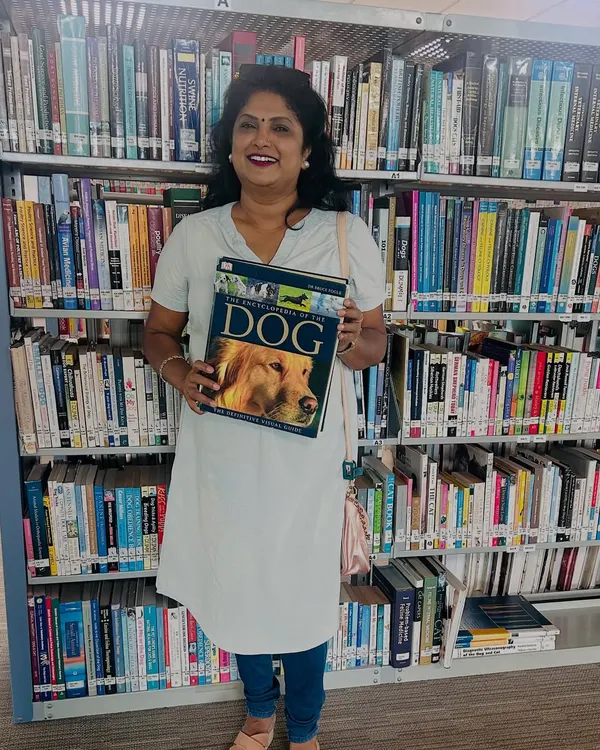 As a dedicated pet care professional, I'm always learning. Here I am at a library, brushing up on my knowledge to provide the best possible care for your dogs.