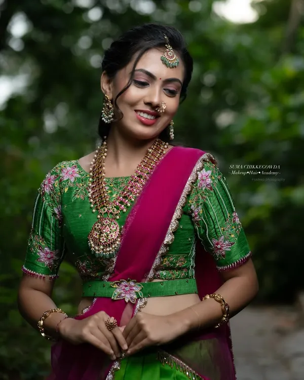 This look, created for an Airbrush Masterclass, features a vibrant green and pink lehenga. The makeup is fresh and dewy, with a focus on glowing skin and bright eyes, perfect for a festive occasion.