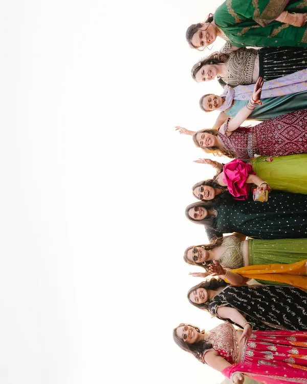 The bride's squad, full of energy and joy. This fun, low-angle shot captures the excitement and support of the bridesmaids, a key part of the wedding celebration.