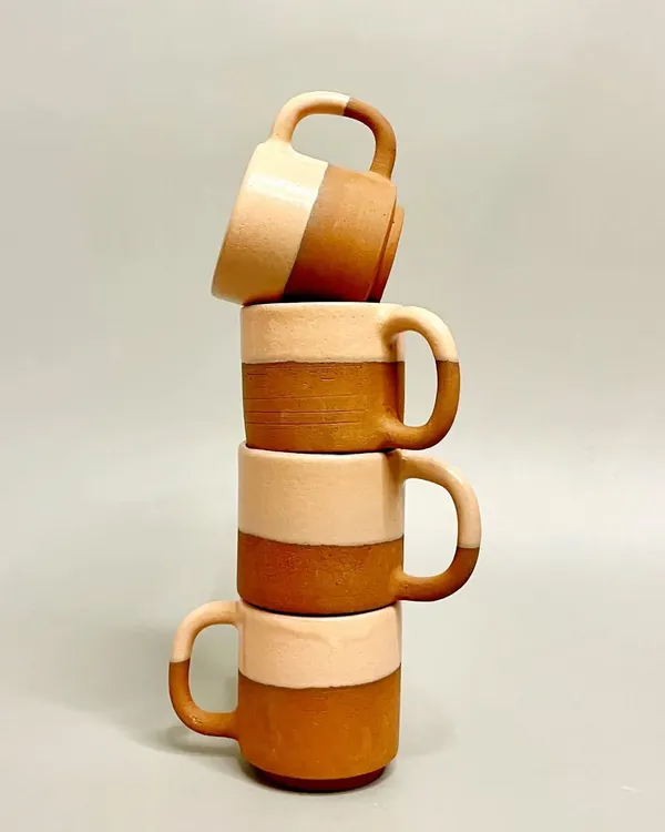 This stack of two-tone mugs showcases the beauty of raw terracotta clay paired with a smooth, light glaze. They are designed for daily use, bringing a touch of handmade artistry to your coffee or tea.